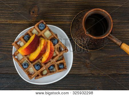 Chocolate Belgian Waffles With Fruits And Coffee Pot On Wooden Background. Delicious Breakfast. Top 