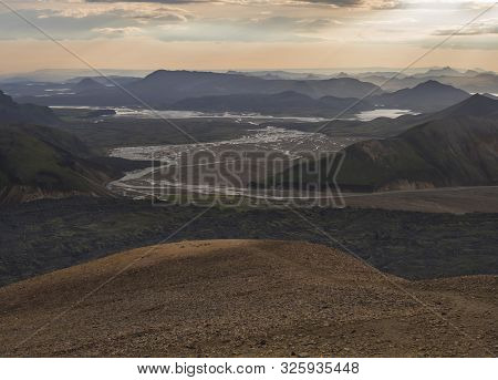 Colorful Rhyolit Mountain Panorma With View On Landmannalaugar Campsite At River Delta. Sunrise In F