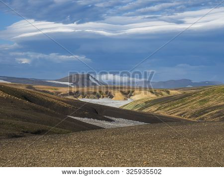 Colorful Rhyolit Mountain Panorma With Snow Fiields And Multicolored Volcanos In Landmannalaugar Are