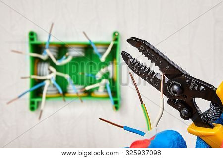 Installation Of Home Wiring. The Bare Ends Of Copper Electric Wires Inside An Electrical Junction Bo