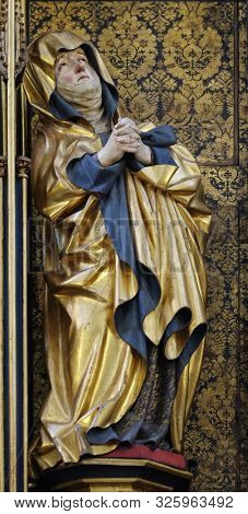 ROTHENBURG, GERMANY - JULY 16, 2019: Virgin Mary under the Cross, Twelve Apostles altar in St James Church in Rothenburg ob der Tauber, Germany