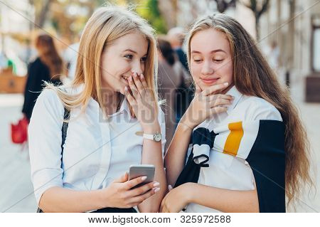 Happy Brightful Positive Moments Of Two Stylish Girls Hugging On Street In City. Closeup Portrait Fu