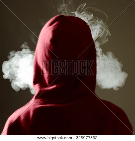 Young Male In Red Hoodie Vaping Smoking, Exhales Thick Vapor, Isolated Rear View