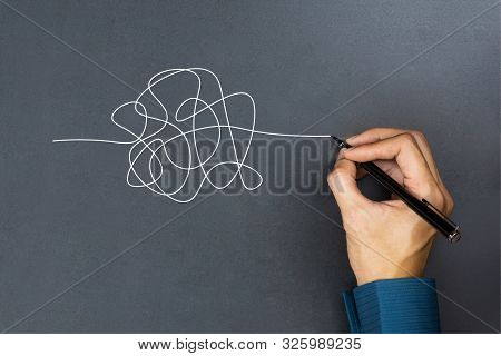 The Way To Business Thinking Success Concept. A Businessman Hand Drawing A White Tangle Line On Blac