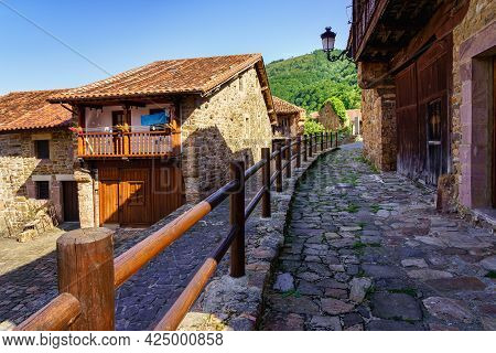 Old Stone Houses With Wooden Fencing In The Streets. Barcena Mayor Santander.