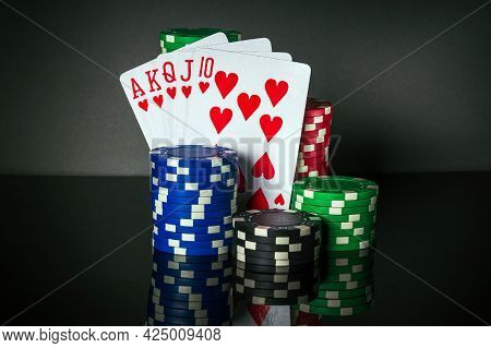 Poker Cards With Troyal Flush Combination. Close-up Of Playing Cards And Chips In Poker Club