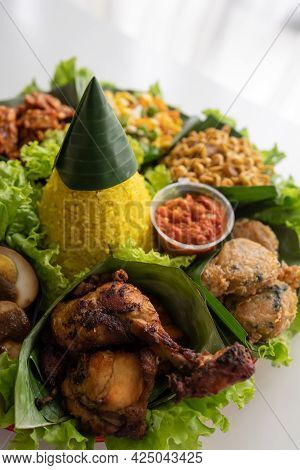 Nasi Tumpeng. Indonesian Cuisine Yellow Rice On Banana Leaf