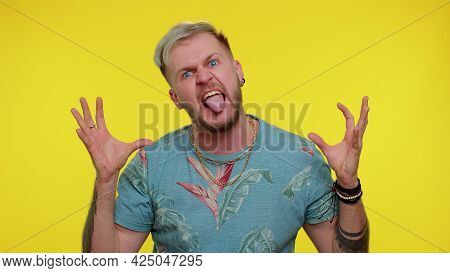 Little Bit Crazy. Portrait Of Bearded Adult Guy 30 Years Old In Fashion T-shirt Demonstrating Tongue