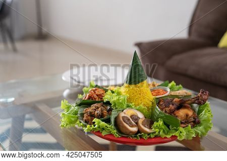 Nasi Tumpeng. Indonesian Cuisine Yellow Rice On Banana Leaf