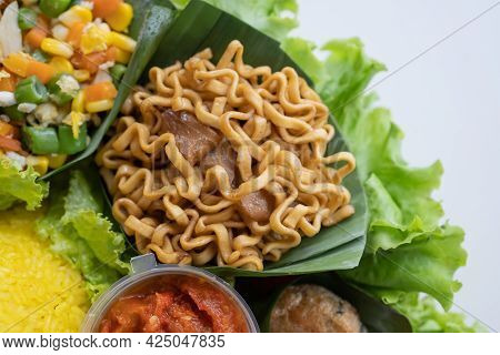 Nasi Tumpeng. Indonesian Cuisine Yellow Rice On Banana Leaf