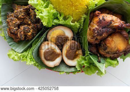 Nasi Tumpeng. Indonesian Cuisine Yellow Rice On Banana Leaf