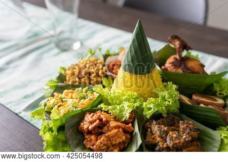 Nasi Tumpeng. Indonesian Cuisine Yellow Rice On Banana Leaf
