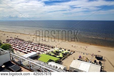 Latvia, Jurmala, June, 26, 2021 - People Enjoying Relaxing On The Baltic Sea Beach In Jurmala, Latvi