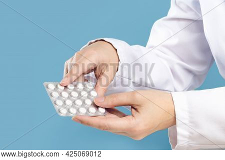 Female Doctor Pointing At Pills. Medicine And Pharmacy