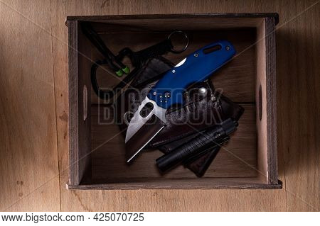 Pocket Knife And Other Everyday Items. Wallet And Knife In A Box. Carabiner And Knife.