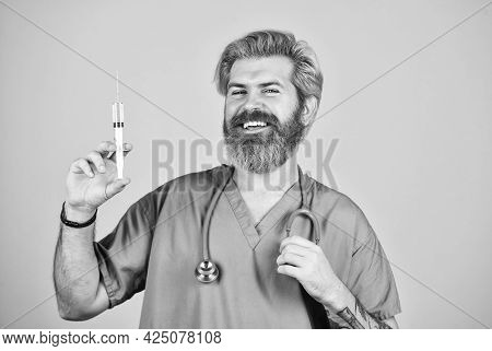 Coronavirus Epidemic From China. Mature Doctor Use Syringe In Hospital . Skilled Nurse Make Injectio