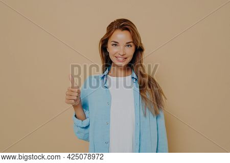 Happy Young Caucasian Female In Blue Shirt With Long Sleeves Rolled Up Weared Over White Tshirt Maki