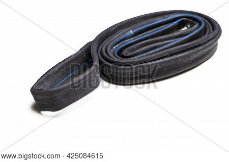 Closeup Image Of Set Of Four Different Road Bike Folded Tyres Placed Together Over White Background.