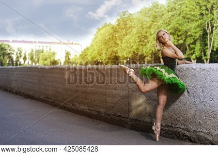 Dancing Concepts. Portrait Of Professional Caucasian Ballet Dancer In Green Tutu Dress Making Up Her