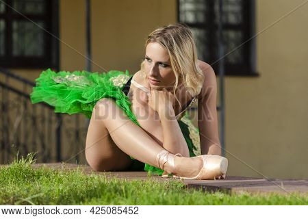 Dancing Concepts. Portrait Of Professional Caucasian Ballet Dancer In Green Tutu Dress Making Up Her