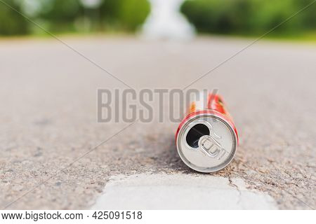 Aluminum Can Is Flat Lay,lying On The Road. Can Fall On The Street, It Can Be Recycled.summer Day Bl