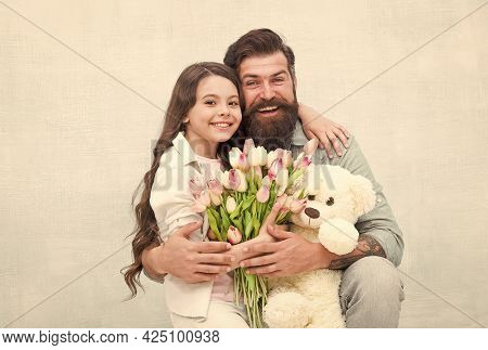 Best Day Ever. Happy Family Celebrate Holiday. Little Child And Father Hold Flowers And Toy. Holiday