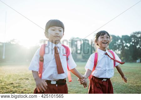Primary School Student Friend Wearing Indonesian Uniform Going To School