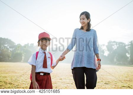 Mother Walk Her Child To School In The Morning
