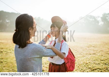 Mother Fixing Her Daughter Primary School Student Uniform