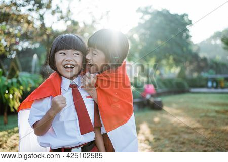 Indonesian School Student Holding Flag During Independence Day.