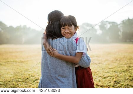 Asian Mother Embrace And Hug Her Daughter Going To School