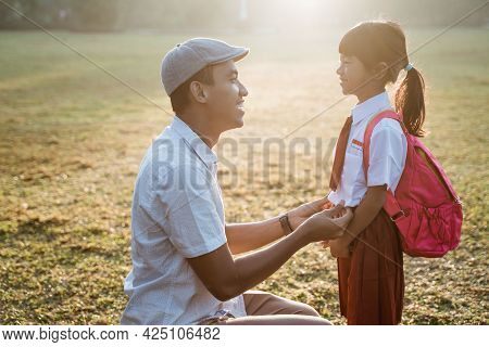 Father Taking Her Daughter To Primary School In The Morning