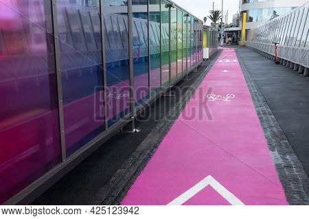 Auckland New Zealand - June 19 2021; Pink Cycle Lane On Footpath Between Bus Stop And Glass Wall On 