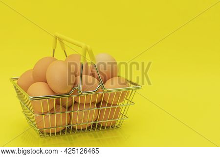 Raw Chicken Eggs In A Basket On A Yellow Background. Eggs In A Metal Cart On A Yellow Background. Ba