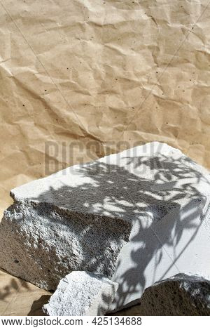 Creative Grey Stone Podium For Cosmetics Or Products On Craft Paper Background. Modern Presentation 