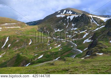 Beautiful scenic view in a rainy and cloudy day over the Transalpina road, the highest mountain road in the Carpathians located in the Parang mountains, Romania, Europe