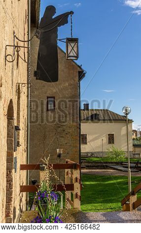 Vadstena, Sweden - May 23, 2021: Entrance To Monastery Hotel In Vadstena With Silhouette Of Nun Hold