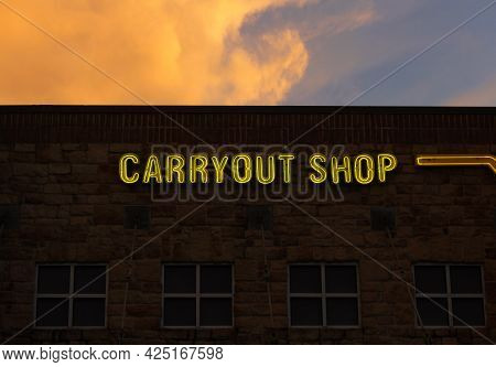 Vintage Neon Carryout Sign On Brick Building