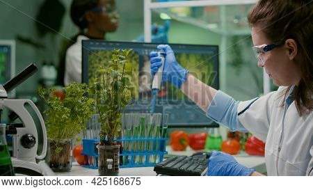Biologist Researcher Using Micropipette Putting Genetic Solution In Test Tube Developing Gmo Medical