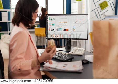 Businesswoman Eating Tasty Sandwich Having Meal Break Working In Business Company Office During Take