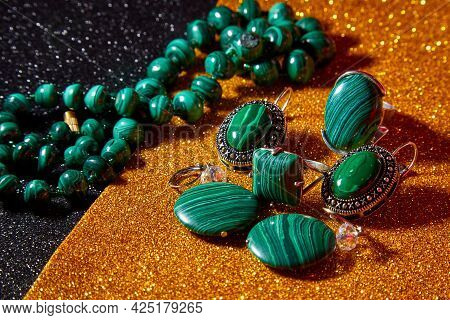 Jewelry From Green Malachite. Malachite Beads And Earrings In The Studio