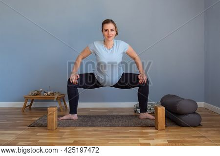 Pregnant Woman Standing In Sumo Squat Exercise, Goddess Pose