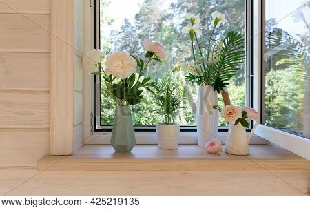 White Window With Mosquito Net In A Rustic Wooden House Overlooking The Garden. Bouquet Of White Iri