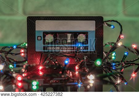 Krasnodar, Russia - March 11, 2021: A Black Maxell Audio Cassette Is Reflected In A Glossy Black Bac