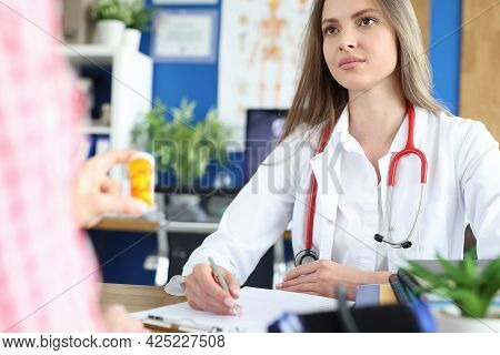 Doctor Advises Patient On Medication Intake Closeup