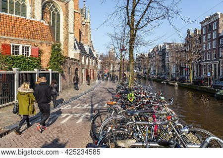 Amsterdam, Netherlands -12 March 2016: Boats On The Amstel Canal And People Walking Around. Bridge O