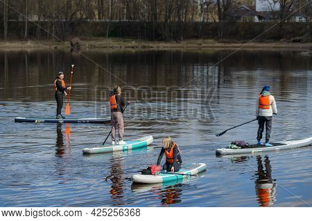 Vyborg, Russia, May 2, 2021-group Of Young People In Sports Outfit And Orange Life Vests Surf On Sup