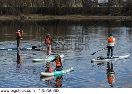 Vyborg, Russia, May 2, 2021-group Of Young People In Sports Outfit And Orange Life Vests Surf On Sup