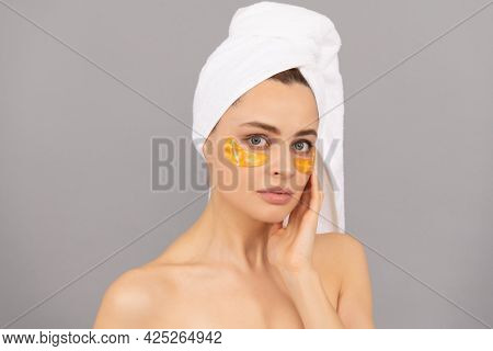 Pamper Your Skin. Beauty Day In Spa. Applying Golden Anti-fatigue Mask. Girl Reduce Eye Bags