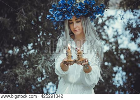 Beautiful Girl In Wreath Of Flowers In Forest. Portrait Of Young Beautiful Woman Wearing White Bride